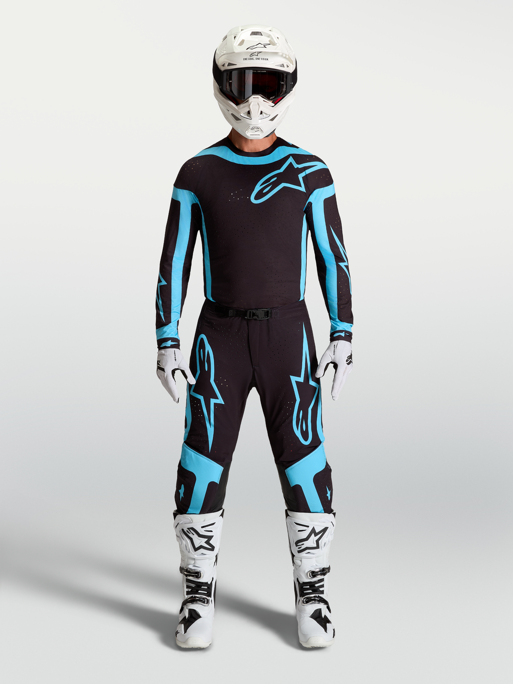 Alpinestars Supertech Vesta Jersey and Gear Set, Men's Motocross Outfit, Black and Turquoise with White Boots and Helmet.