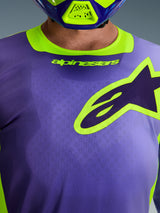 Alpinestars 2026 Racer Portl Jersey, Motocross Jersey, Purple and Yellow Fluo, close-up of chest area featuring a large yellow-outlined Alpinestars logo, stretch collar with branding, technical moisture-wicking polyfabric