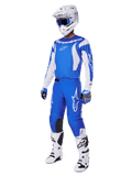 Motocross rider wearing the complete 2025 Fluid Haul Gear Set, Blue and White jersey and pants with Alpinestars branding, white helmet with blue goggles, white boots, and blue gloves, coordinated racing outfit for off-road motocross.