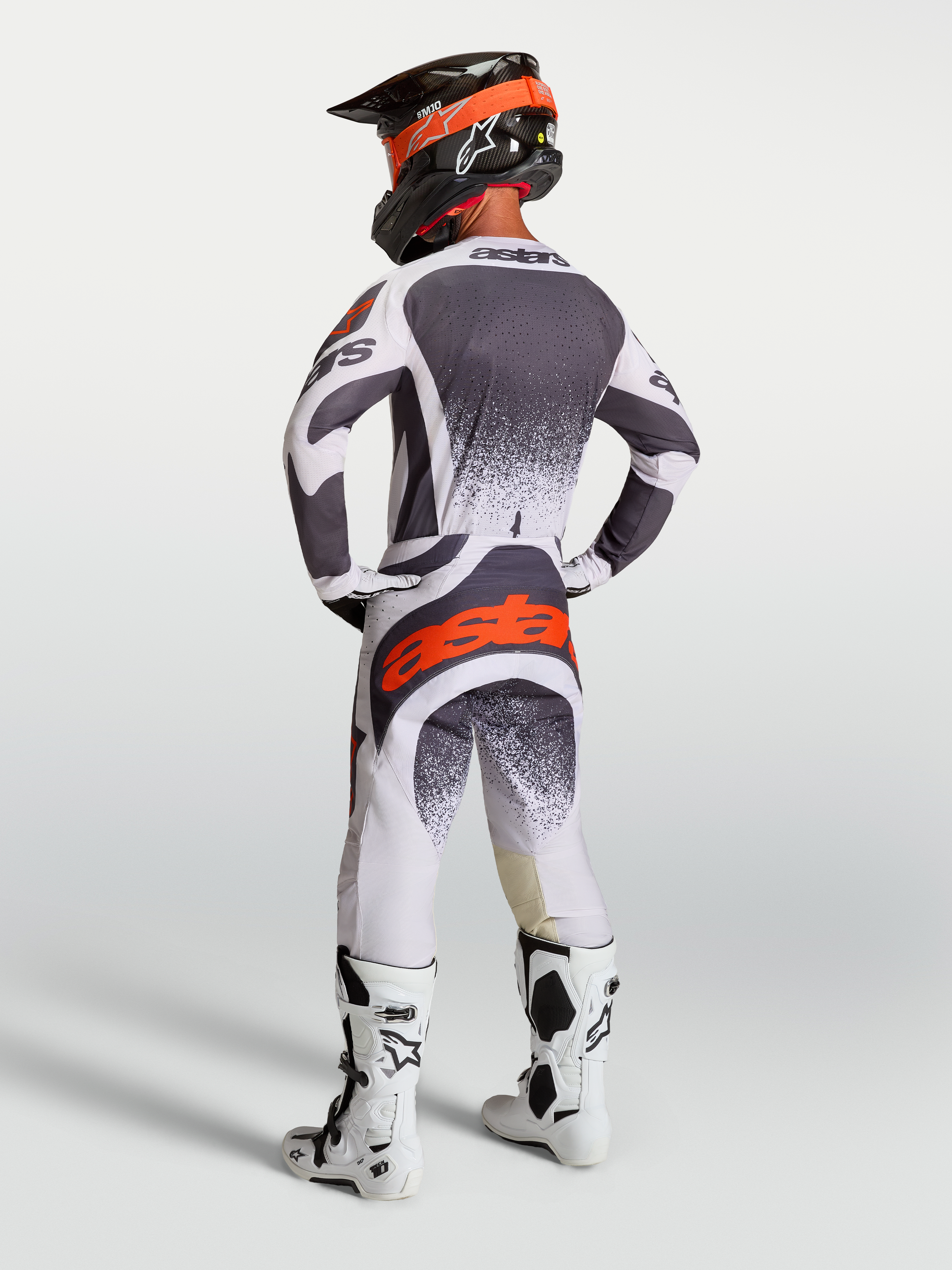 Alpinestars Techstar Swan Jersey AND Gear Set, men's motocross racing outfit in dark gray and red fluo.