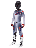 Alpinestars 2025 Supertech Lipan Gear Set, Motocross Racing Gear, Gray with Orange Fluo and Navy Blue star graphics, worn with a black helmet, red and black gloves, and white and black boots, complete professional off-road outfit with ventilated design