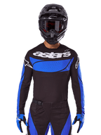 Alpinestars 2025 Techstar Dreem Gear Set AND Jersey, Black and Blue Motocross Outfit, worn by a rider for off-road racing.