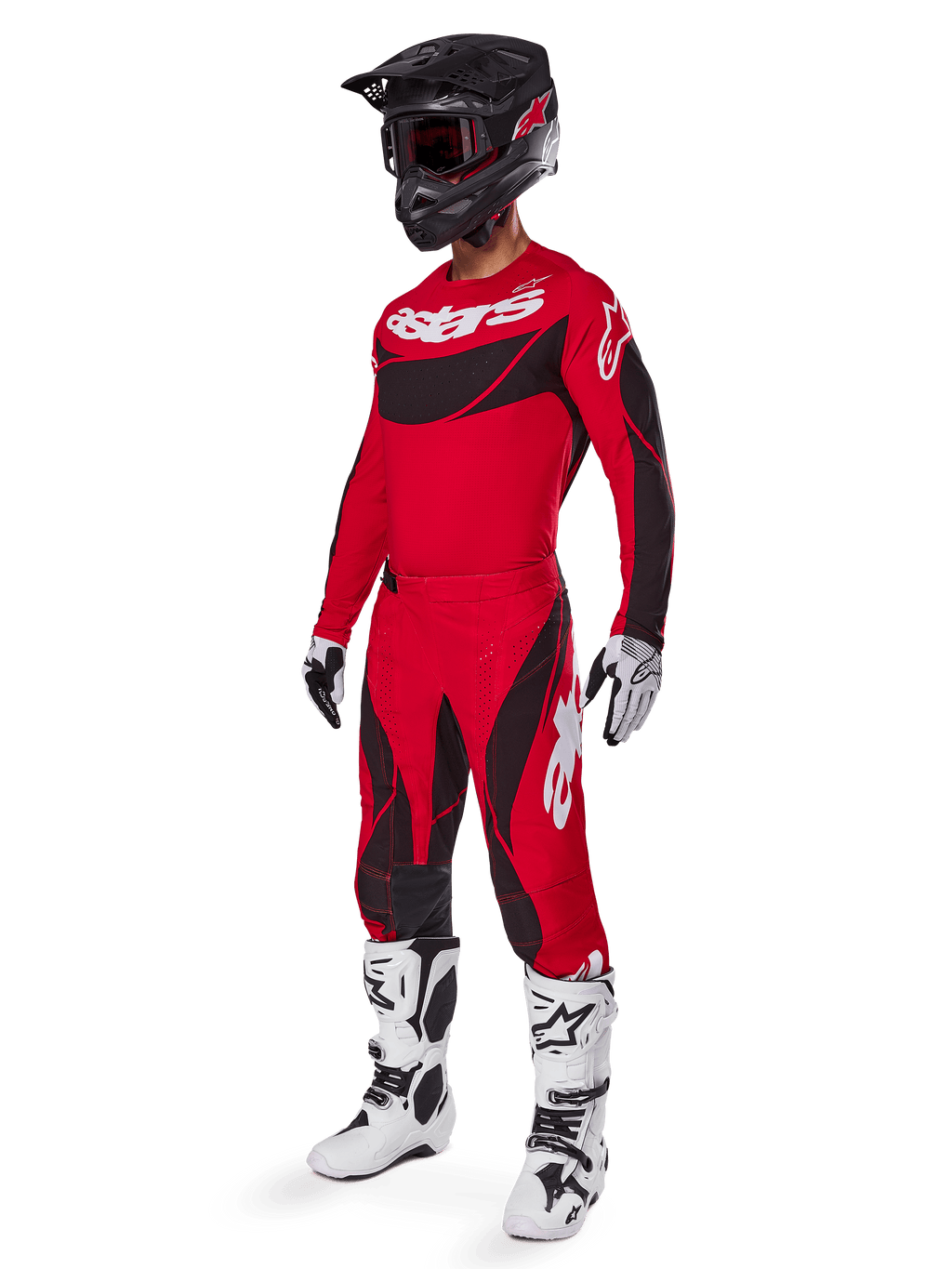 Full-body view of a motocross rider in the 2025 Techstar Dreem Gear Set in Bright Red and Black, featuring a performance jersey with white branding, matching stretch ripstop pants, a black helmet with a red visor, white and black gloves, and white Tech boots, specialized racing outfit for off-road competition.
