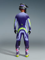 Alpinestars 2026 Supertech Scenz Gear Set, Motocross rider seen from behind wearing purple and lilac gear with neon yellow accents, jersey and pants featuring a gradient dot design, matching helmet and goggles, light purple boots with pink logos and neon yellow soles, professional motocross racing apparel