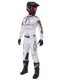 Alpinestars 2025 Racer Hollow Gear Set, Motocross Outfit, White and Grey, jersey and pants with bold 'STARS' branding, black helmet with orange-red tinted goggles, black gloves, and black boots, complete professional gear for dirt biking