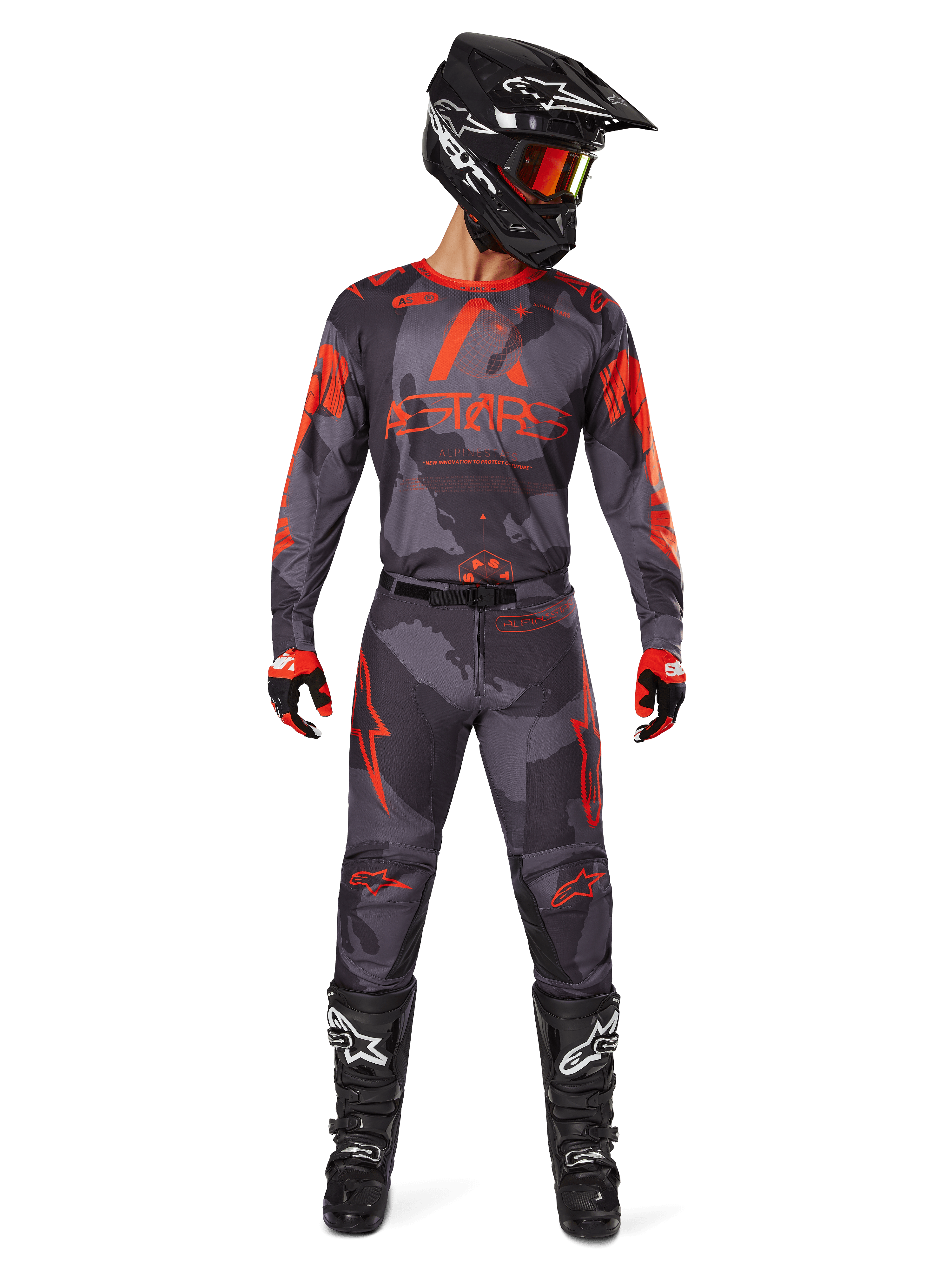 Motocross rider wearing Alpinestars 2025 Racer Hollow Jersey and matching pants in Gray Camo Orange Fluo, complete gear set with black helmet, goggles, gloves, and boots, featuring bold orange logos and camo pattern.