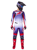 Motocross rider wearing complete Alpinestars racing gear, 2025 Fluid Wurx Jersey in Purple Bright Red with white accents and large red star logo, matching pants, red boots, and black helmet with goggles, coordinated outfit for off-road racing