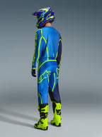 Alpinestars 2026 Fluid Apex Gear Set, motocross rider shown from the back wearing a blue and neon yellow gear set, blue jersey and pants with neon yellow logos, neon yellow boots, purple and blue helmet, coordinated off-road racing apparel.