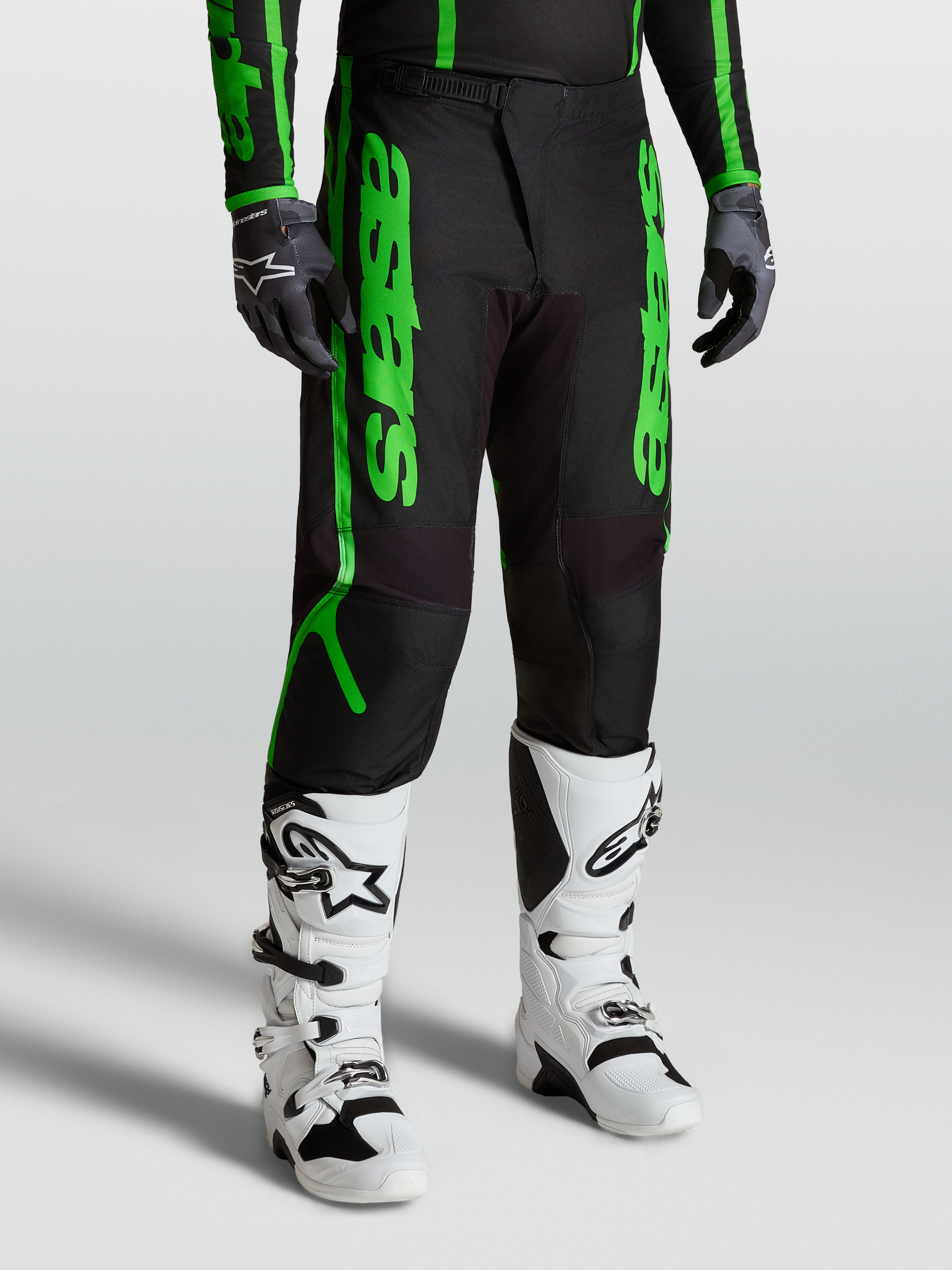 Alpinestars Fluid Apex V2 Pants, men's motocross performance gear in black and fluorescent green with reinforced 600D polyfabric.
