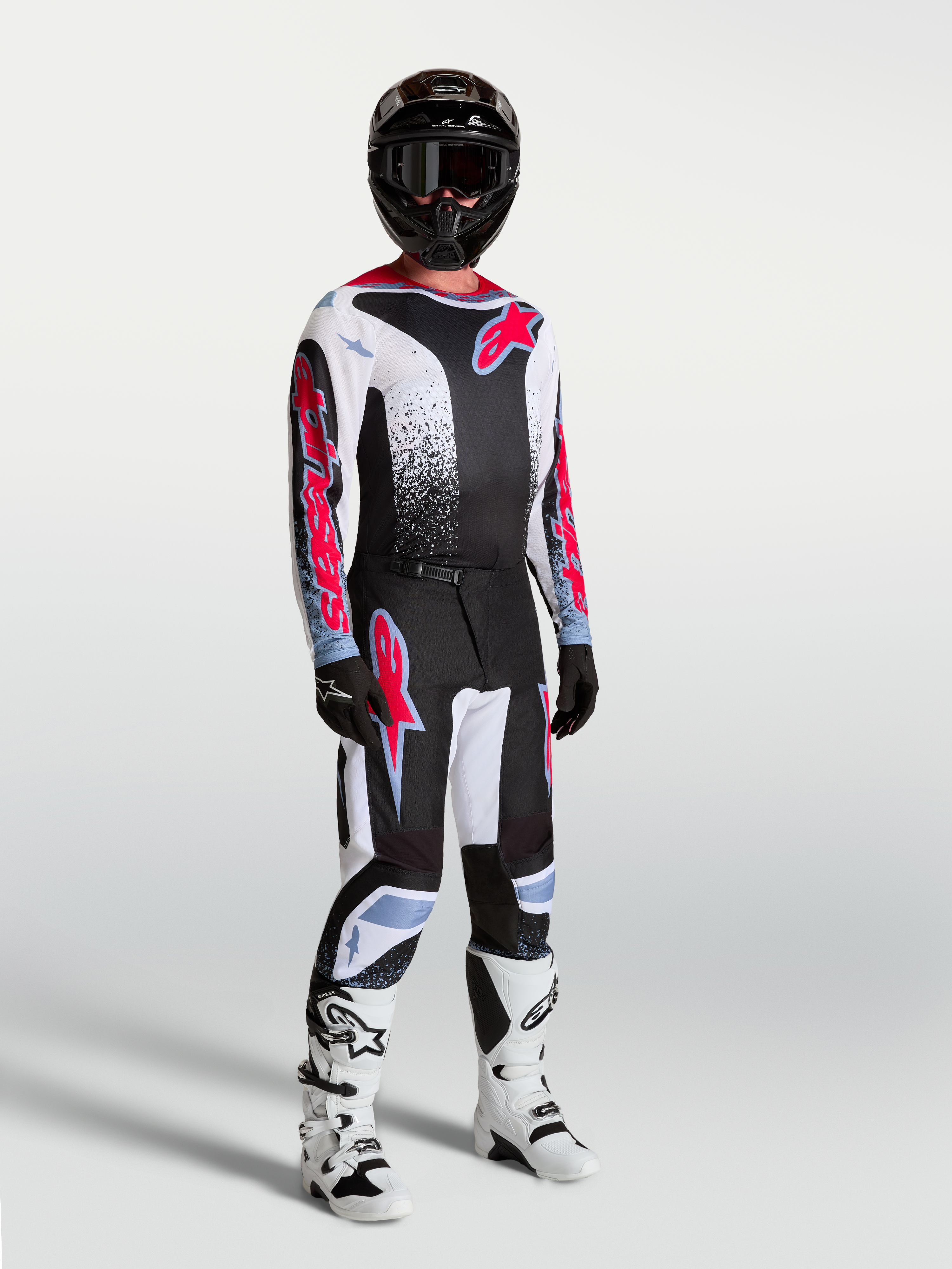 Alpinestars Fluid Drag Jersey, Men's Motocross Jersey, Black, White, and Red Fluo, breathable textile on model with full gear.