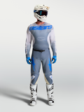 Alpinestars 2027 Racer Amber Jersey and Gear Set, motocross outfit in Ash Gray and Blue, on-model with white helmet and boots.