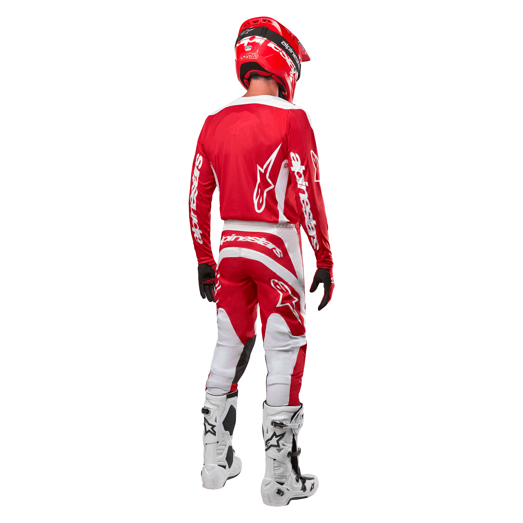 Rear view of a motocross rider wearing the Alpinestars 2024 Fluid Lurv Jersey in Mars Red White, paired with matching red and white pants, white off-road boots, and a red helmet, showing the jersey's back design and Alpinestars branding.