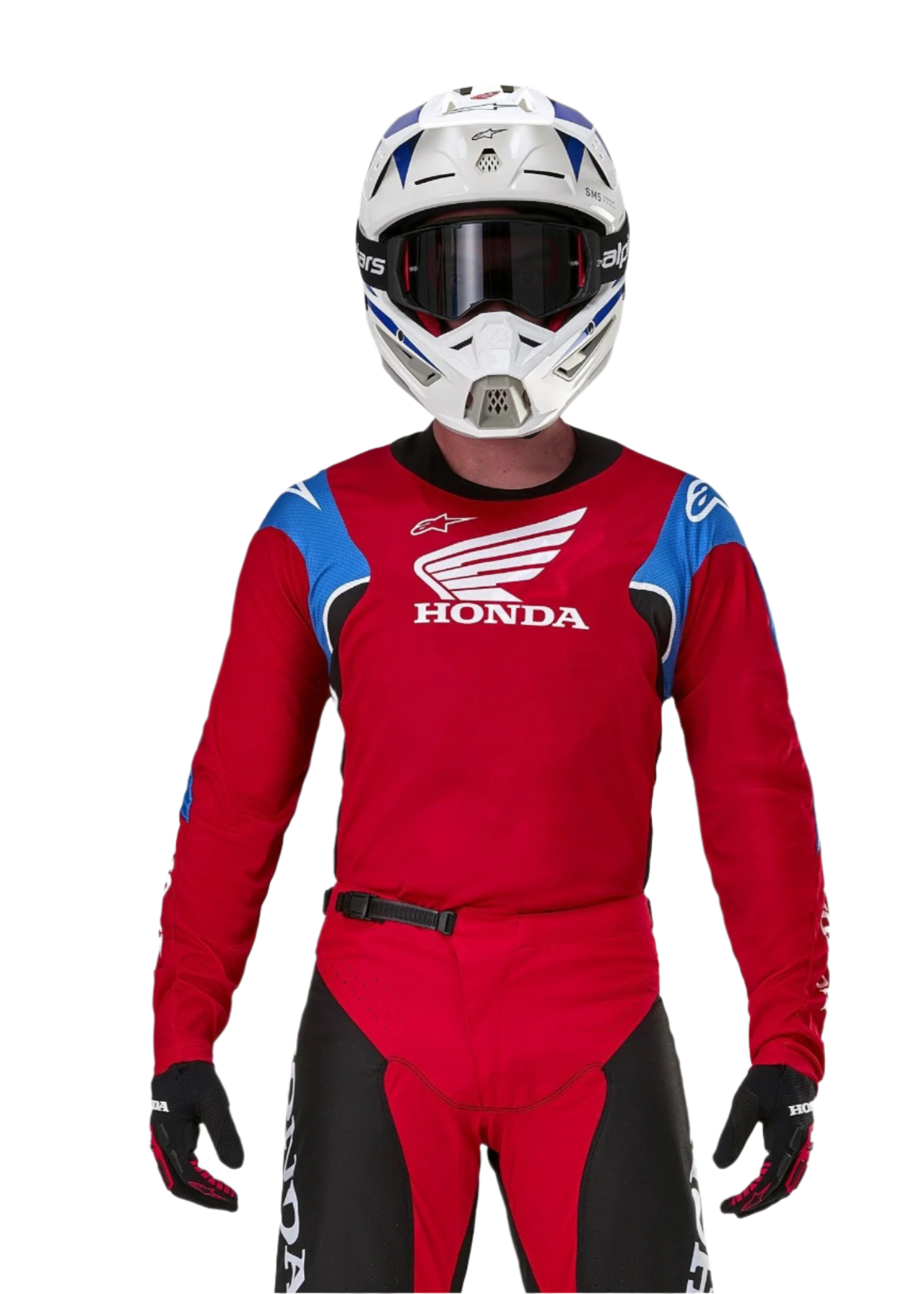 Motocross rider wearing the Alpinestars Honda Racer Iconic Jersey, Red with blue shoulder panels and white Honda logo, paired with matching red and black pants and a white motocross helmet, professional off-road racing gear