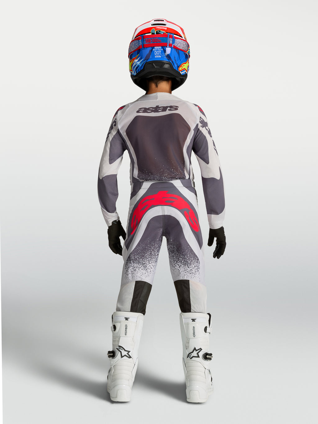 Alpinestars 2027 Youth Supertech Swan Jersey and Gear Set, gray and white motocross gear with red accents, rear view.