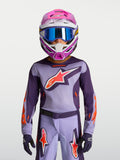 Alpinestars 2027 Youth Fluid Hunt Jersey, purple and pink fluo youth motocross gear, on-model with racing helmet and goggles.