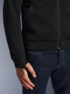 Alpinestars Chrome Superairflow Hoodie, Black, close-up of high-resistance 3D technical mesh fabric, featuring ribbed stretch jersey cuff with elastic retention thumb loop, worn with blue jeans