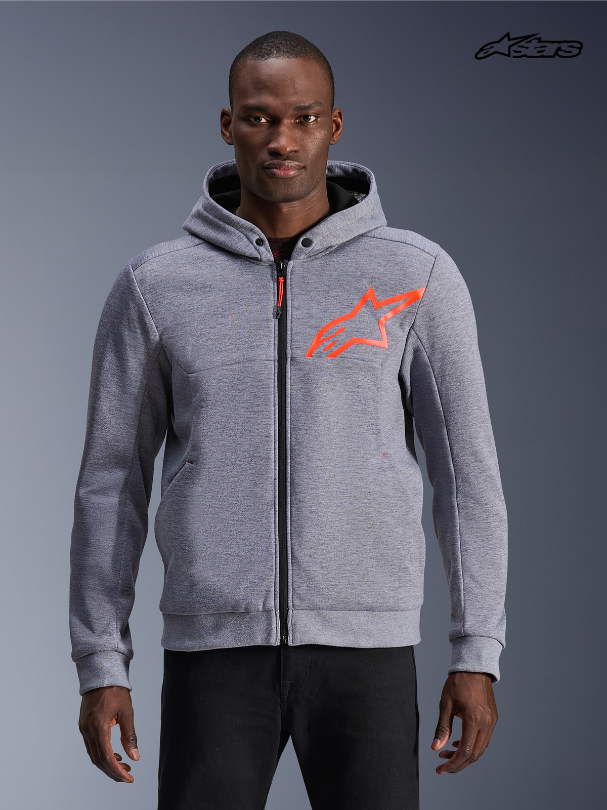 Alpinestars Chrome V2 Sport Hoodie, men's urban motorcycle hoodie in gray heather with red fluo accents, front view on a model showing tech fleece construction and protective zip styling.
