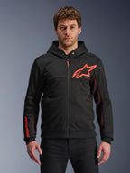 Alpinestars Chrome Air Sport Hoodie, Black zip-up hoodie with red fluo star logo and sleeve accents, red mesh side panels for ventilation, casual urban riding gear worn by a model