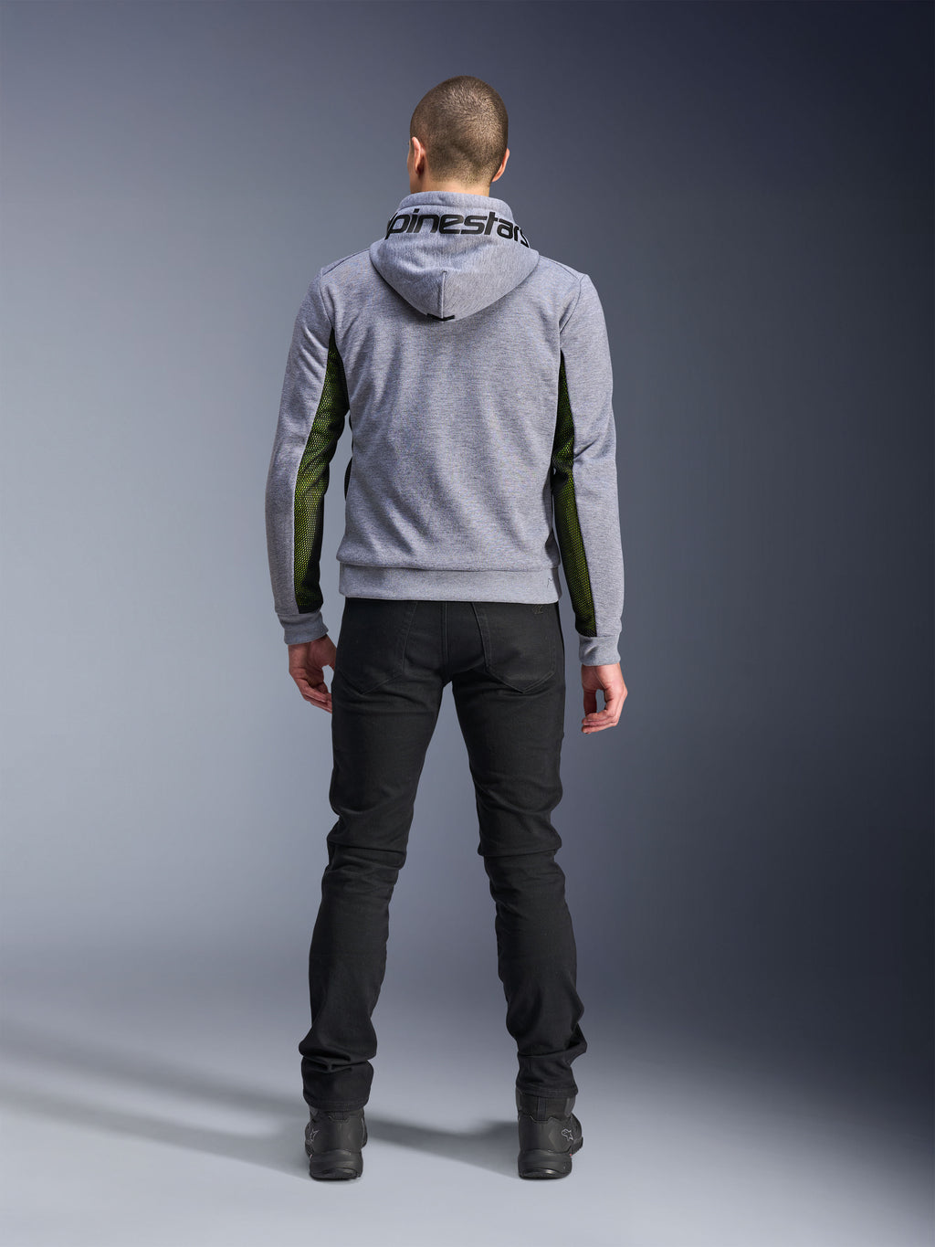 Alpinestars Chrome Air Sport Hoodie, Gray Heather Black, back view of motorcycle riding hoodie featuring green high-flow mesh panels on the sides and sleeves, tech fleece construction with Alpinestars branding on the hood, worn with black pants