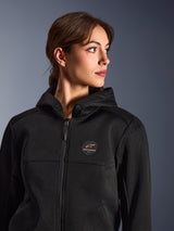 Woman wearing the Alpinestars Stella Chrome Superairflow Hoodie, Black with copper logo, 3D mesh construction for maximum airflow, technical motorcycle gear designed for women, urban sport riding style