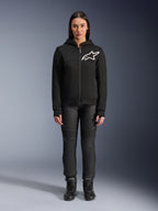 Woman wearing Alpinestars Stella Chrome V2 Sport Hoodie, Black with white Astars logo on the chest, paired with black technical riding pants and boots, urban motorcycle apparel design.