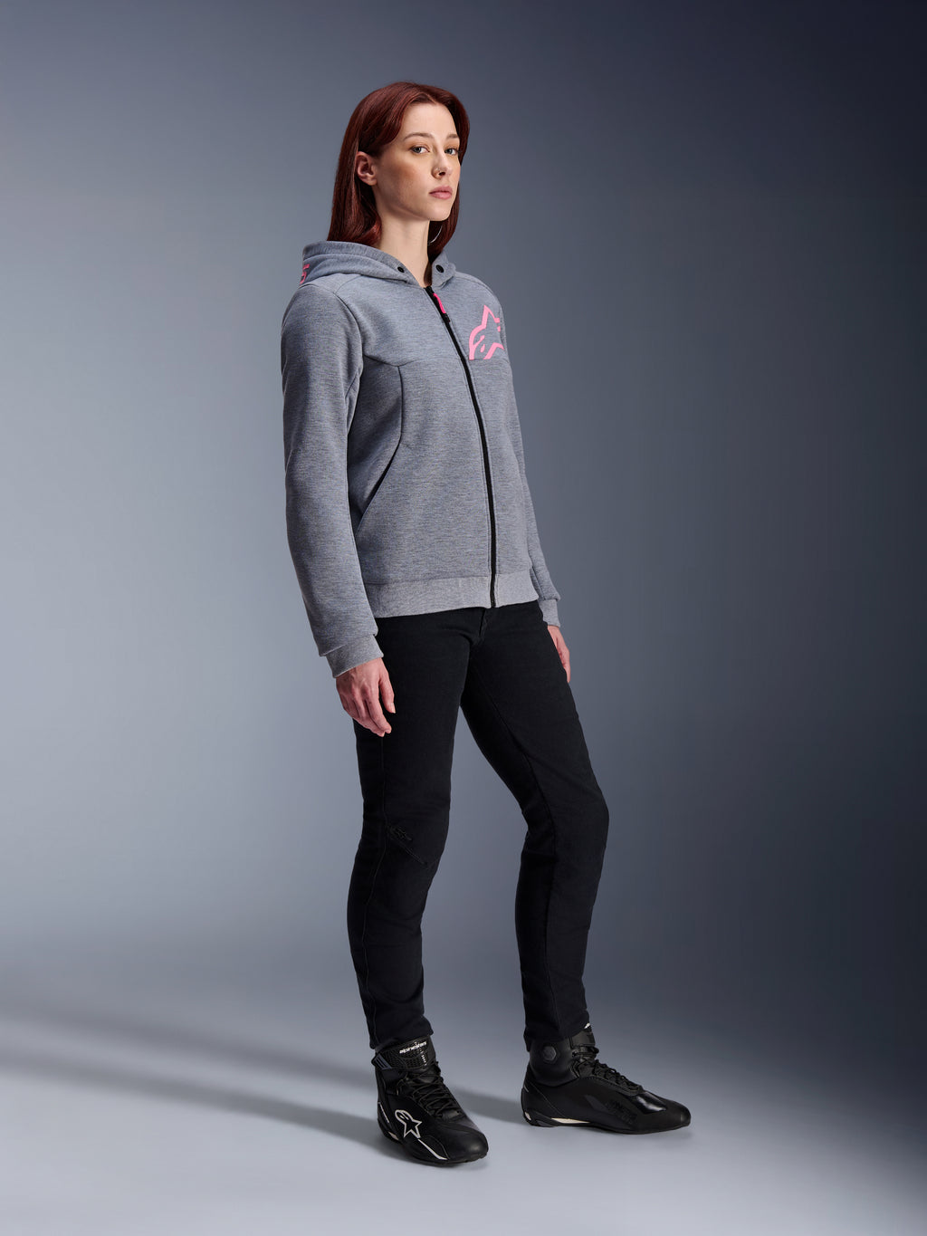 Alpinestars Stella Chrome V2 Sport Hoodie, Women's Motorcycle Hoodie, Gray Heather and Pink Fluo, worn with black riding pants and black boots, casual urban riding gear