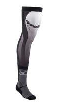 Alpinestars Knee Brace Socks, long motocross riding socks, Black White and Gray, over-the-knee design with stretch Lycra upper, mesh inserts, ribbed ankle padding, and Alpinestars branding on the thigh