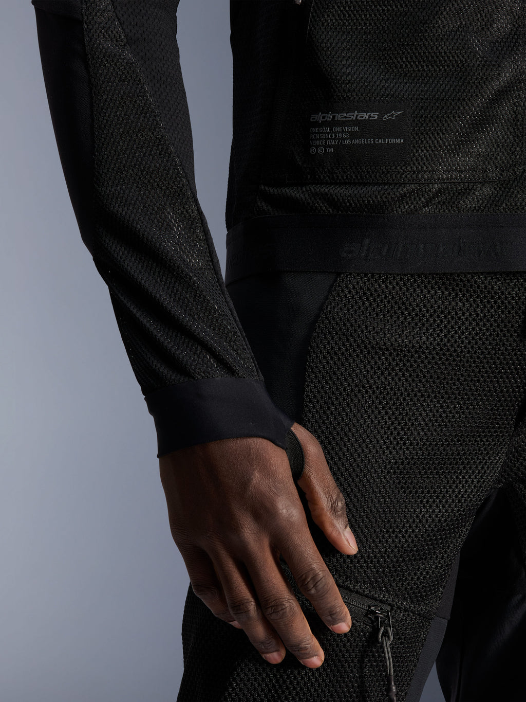 Alpinestars Troop-Air Jacket, Black, close-up showing technical mesh construction, branded patch with technical text, and sleeve with integrated thumb-hole loop, urban summer motorcycle jacket with high-airflow design