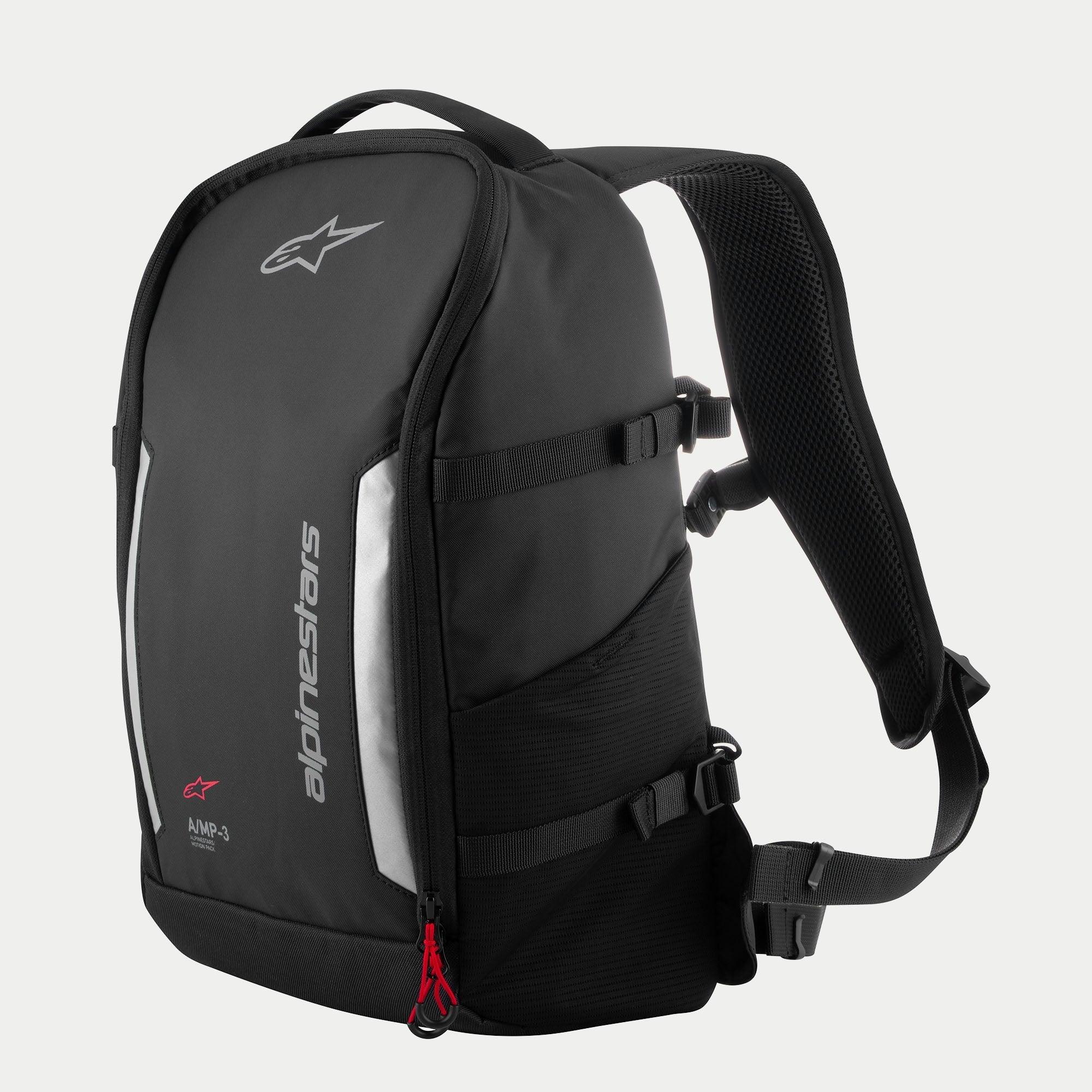 Alpinestars AMP3 Backpack, Black technical motorcycle bag with white logos, silver reflective panels, red zipper pulls, adjustable side compression straps, and padded mesh shoulder straps.