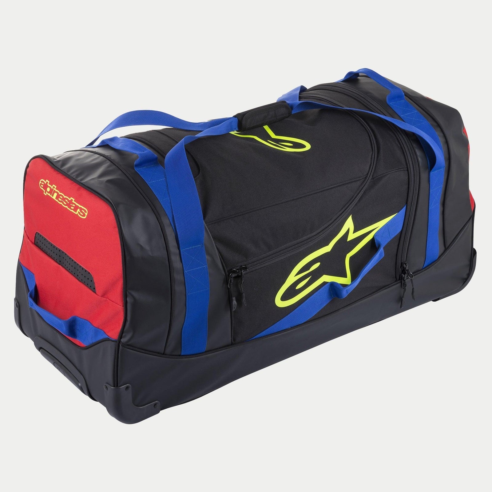 Alpinestars Komodo Travel Bag, rolling gear bag, Black Blue Red and Yellow Fluo, featuring blue webbing handles, a red side panel, and fluorescent yellow logos, durable construction with wheels for transporting motocross and racing equipment