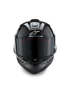 Alpinestars Supertech R10 Solid Helmet, Front View, Black Carbon Matte and Glossy finish, visible carbon fiber weave, white Alpinestars logo, dark smoke visor, aerodynamic racing motorcycle helmet
