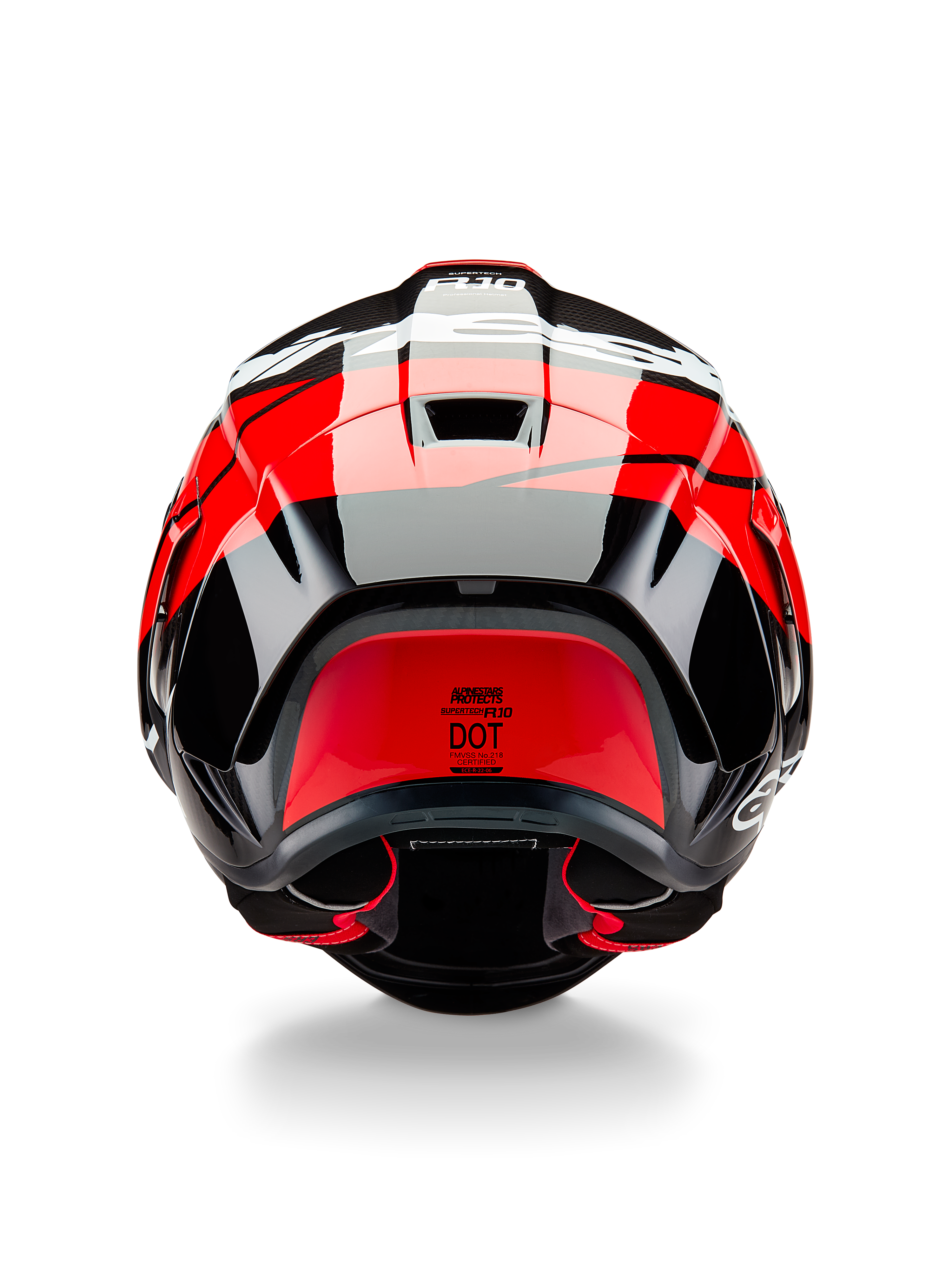 Alpinestars Supertech R10 Element Helmet, rear view, Black Carbon with Bright Red and White Glossy accents, featuring an aerodynamic rear spoiler, exhaust vents, and DOT certification label, sleek racing-inspired design with carbon fiber detailing