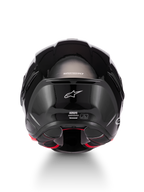 Alpinestars Supertech R7 Solid Helmet, glossy black motorcycle helmet, rear view showcasing aerodynamic carbon composite shell, white Alpinestars logo, and ECE 22.06 certification details