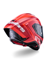 Alpinestars Supertech R10 Arius Helmet, Glossy Red with white branding, Rear three-quarter view showing aerodynamic spoiler, carbon fiber shell construction, and sleek racing profile with a dark visor