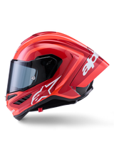Alpinestars Supertech R10 Arius Helmet, Full-Face Racing Helmet, Glossy Red with white logo graphics, side profile view highlighting aerodynamic spoiler and clear visor, carbon fiber composite shell for professional motorsport