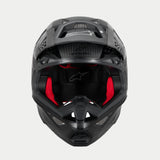 Alpinestars Supertech M10 Fame ECE 22.06 Helmet, Motocross Helmet, Black Carbon Matte and Glossy, front view with visible red interior padding, aerodynamic carbon fiber shell, ventilated design for off-road racing