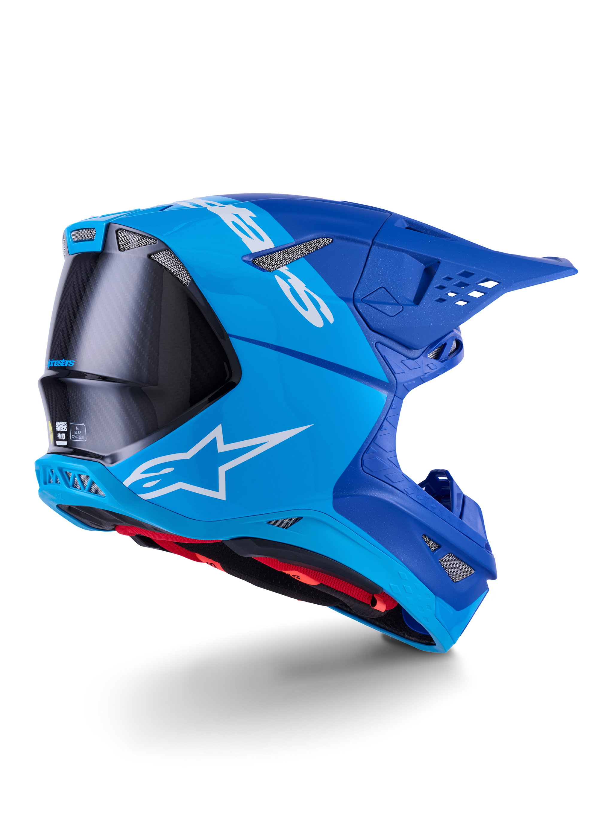 Alpinestars Supertech M10 Flood Helmet, Motocross Helmet, Bright Blue and Navy Blue with exposed Black Carbon fiber, rear-side profile showing ventilation ports and white logo, red interior lining, advanced aerodynamic design for off-road performance
