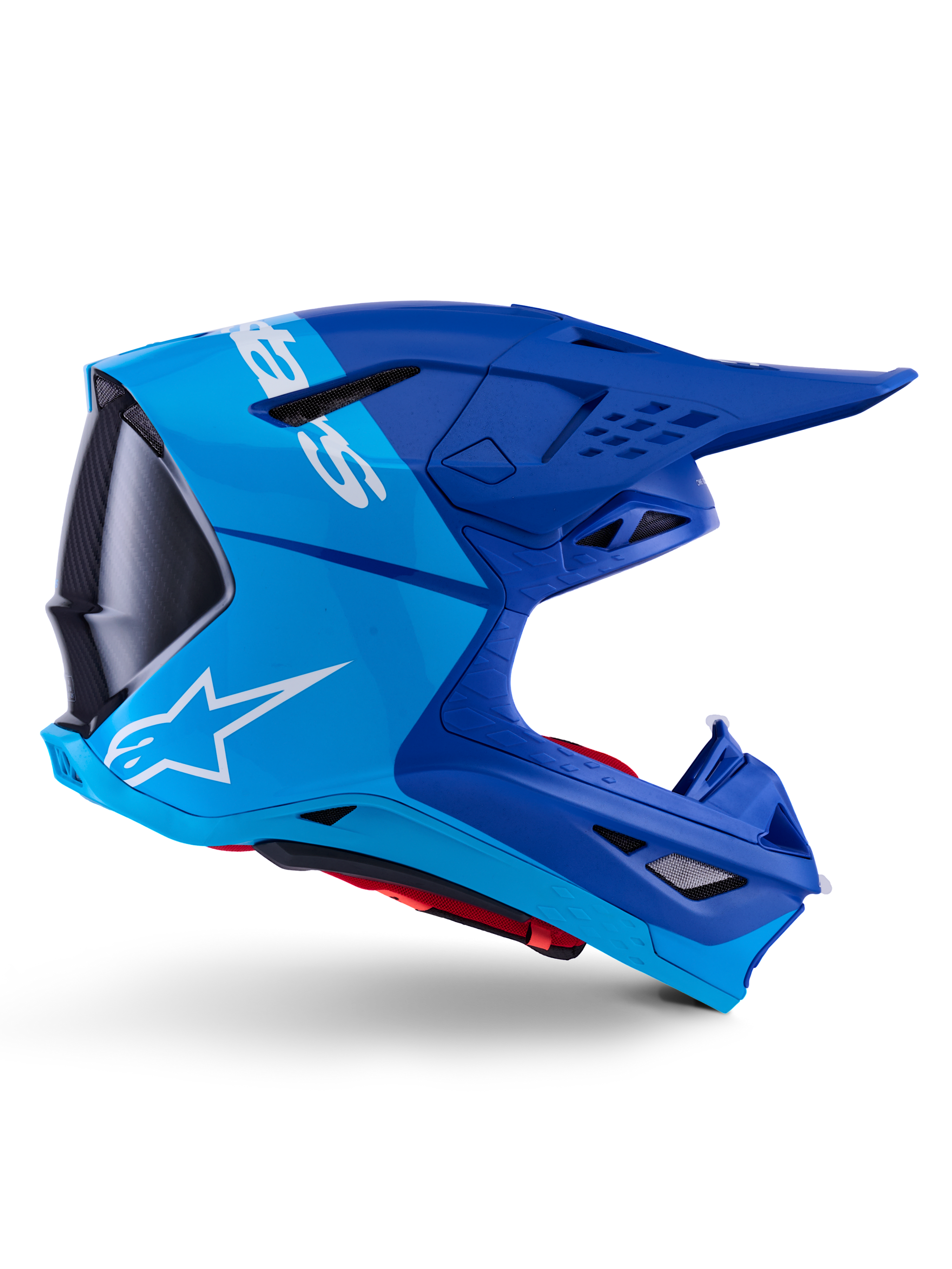 Alpinestars Supertech M10 Flood Helmet, Motocross Helmet, Metallic and Medium Blue with Black Carbon accents, side profile view, featuring a white logo, aerodynamic design with ventilation ports, carbon fiber texture details, professional off-road racing protection