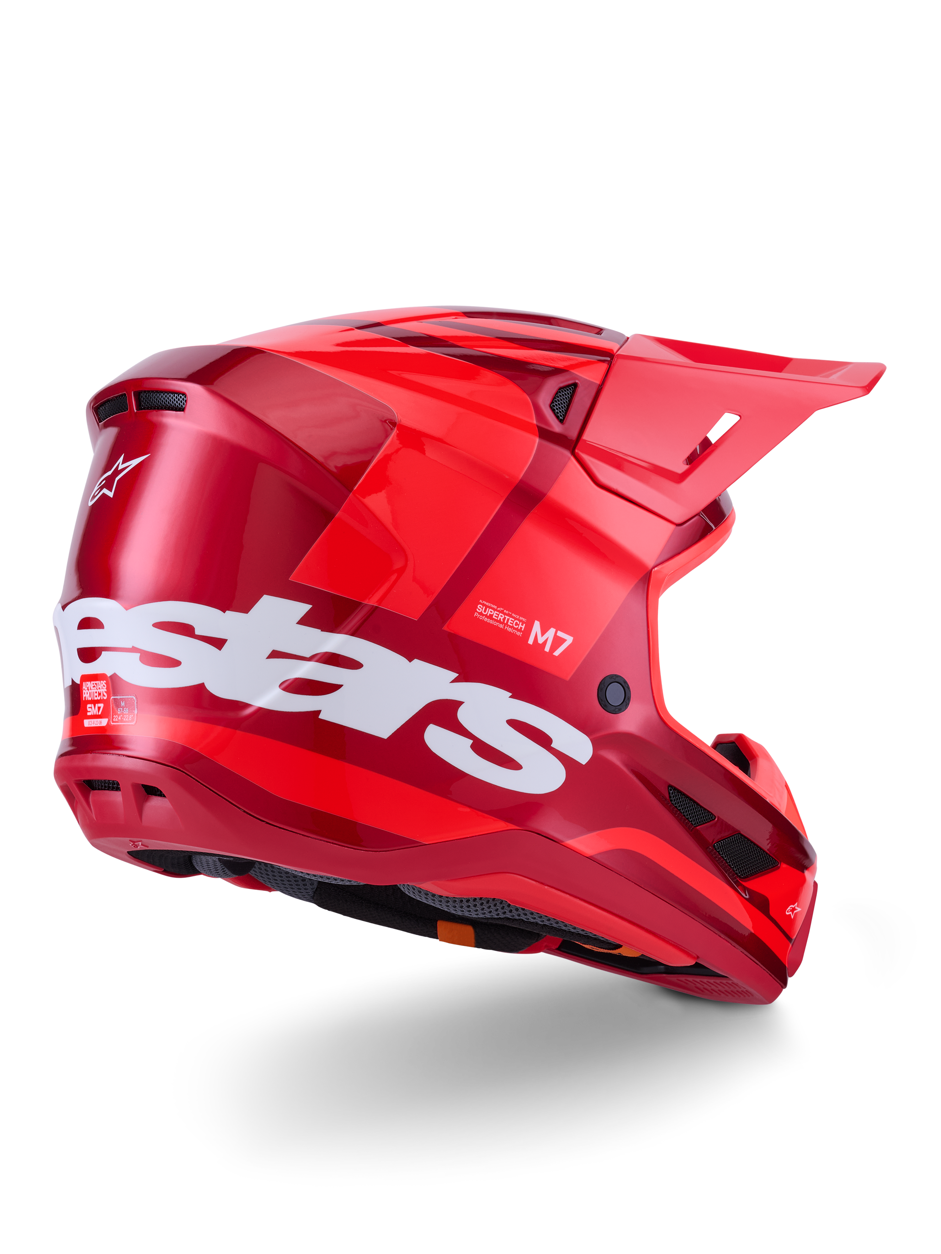 Alpinestars S-M7 Core Helmet, Motocross Helmet, Red Glossy with large white Alpinestars logo on the side, featuring an aerodynamic shell, integrated ventilation ports, and protective visor, 3/4 rear view