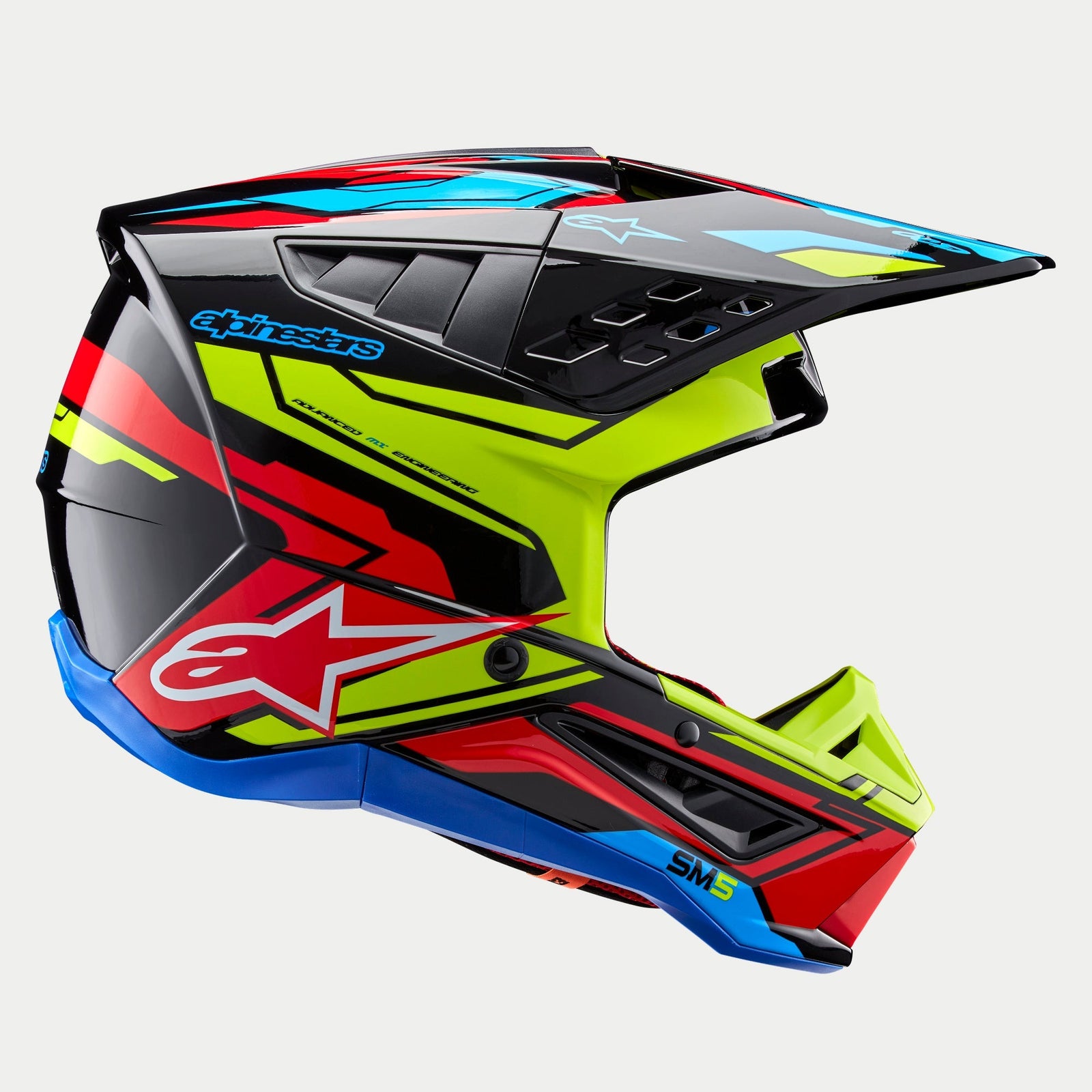 Alpinestars S-M5 Action 2 Helmet ECE, Motocross Helmet, Glossy Black with Yellow Fluo, Bright Red, and Cyan Blue graphics, profile view featuring an aerodynamic shell, ventilated peak, and prominent Alpinestars branding on the side, professional off-road racing protection