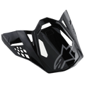 Alpinestars S-M8 Helmet Visor Radium, Glossy Black motorcycle helmet peak with gray Alpinestars logo, featuring aerodynamic angular cutouts and sharp edges, modern racing style for off-road helmets