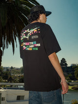 Alpinestars Wild Oversized CSF Tee, Short Sleeve T-Shirt, Black, Vibrant multi-color Astars logo on back, oversized fit, casual streetwear lifestyle shot with palm trees