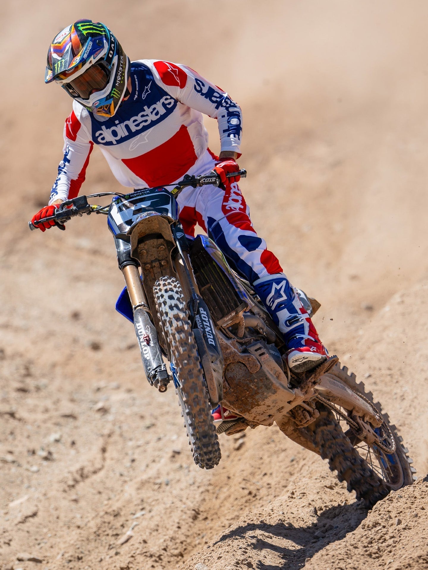 Alpinestars Limited Edition Techstar Fortitude Pants, Motocross Pants, Bright Red White and Blue, worn by a rider in action on a dirt track, featuring matching jersey and boots, performance-driven off-road racing gear.