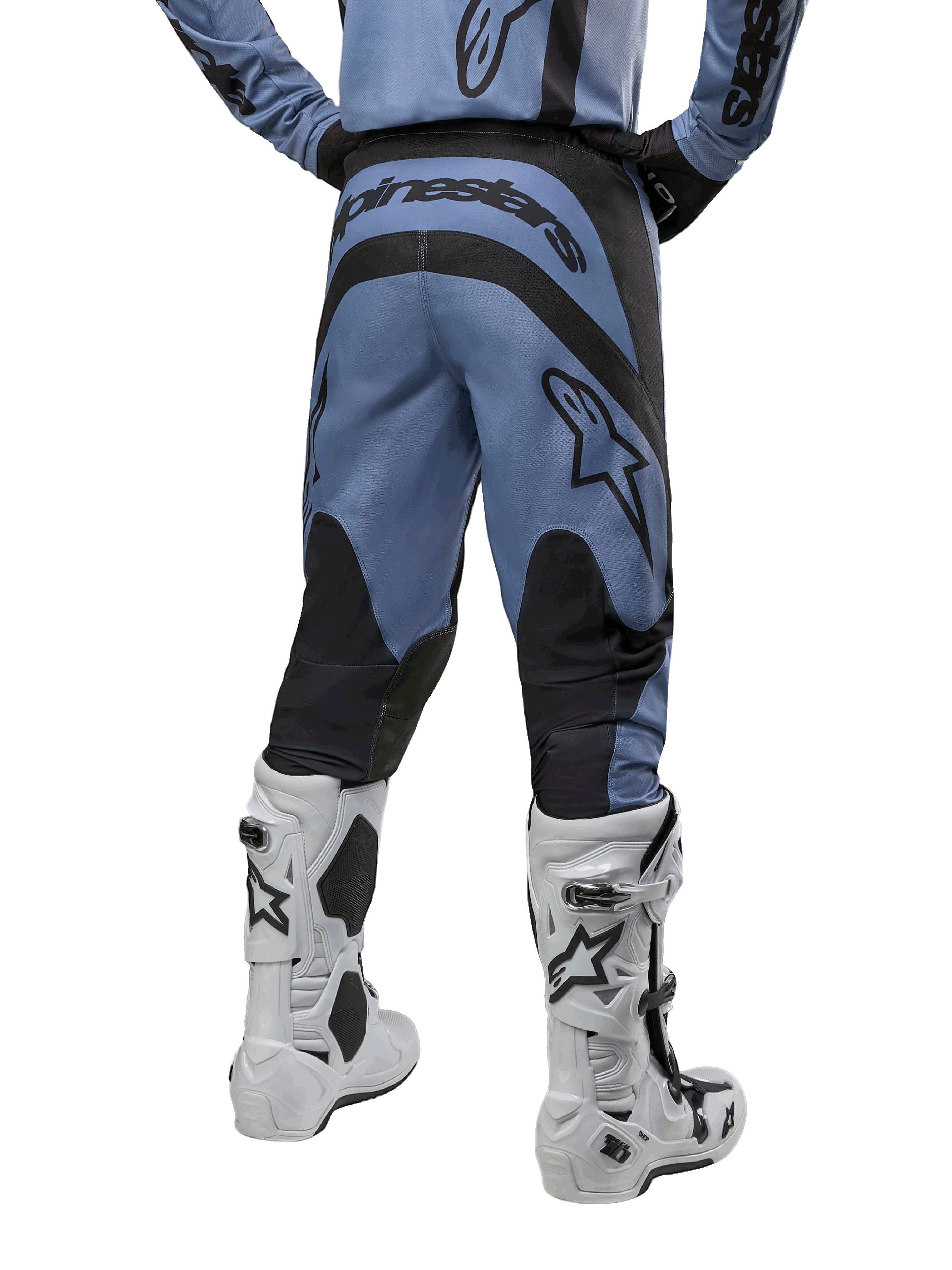 Alpinestars 2024 Fluid Lurv Pants, Motocross Pants, Light Blue and Black, back view showing black reinforced panels and large brand logo, paired with white and black motocross boots, professional racing gear for off-road riding