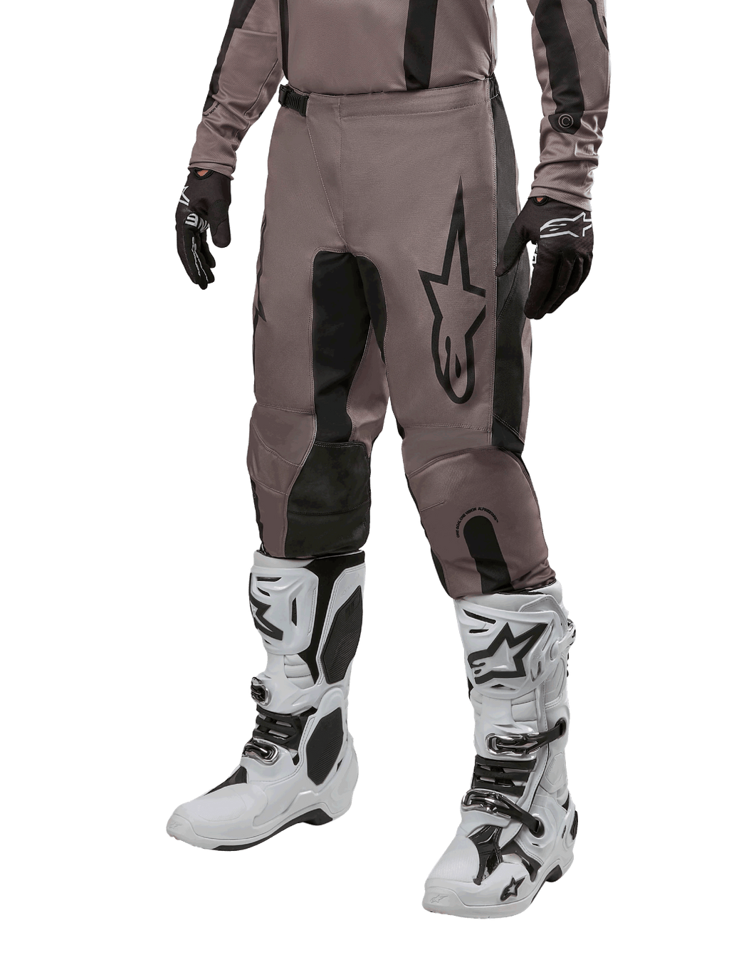 Alpinestars 2024 Fluid Lurv Pants, Motocross Pants, Mud Black and Black, featuring Alpinestars logo, worn with black gloves and white motocross boots, sporty design for off-road racing