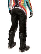 Alpinestars Women Stella 2024 Techstar Pants, Motocross Pants, Black Multicolor, rear view featuring bold white branding across the seat, worn with black Tech 3 boots and a matching multicolor jersey, professional off-road racing apparel.