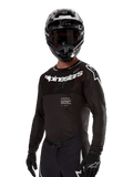 Alpinestars 2024 Supertech Ward Jersey, Motocross Jersey, Black and White, long-sleeve performance gear with bold Alpinestars branding, worn with matching helmet and gloves, athletic fit for off-road riding