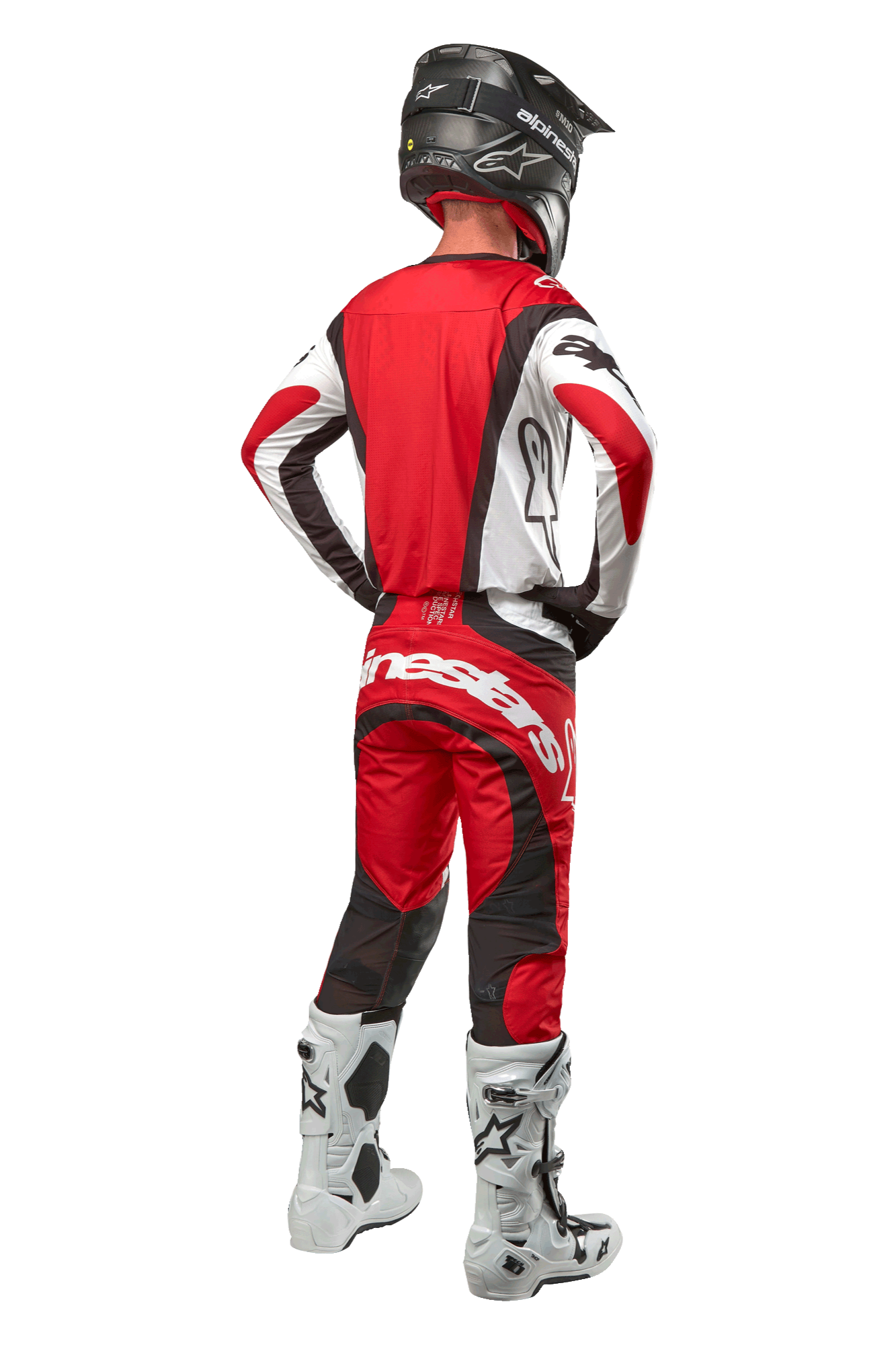 Alpinestars 2024 Techstar Ocuri Pants, Motocross Pants, Mars Red White Black, rear view of a motocross rider wearing full racing gear, including matching jersey, black helmet, and white and black boots, highlighting the Alpinestars branding and durable fabric construction.
