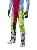Alpinestars 2024 Techstar Ocuri Pants, Motocross Pants, Light Blue, Red Berry, and Neon Yellow, worn with matching gear and white boots, featuring bold Astars branding and a performance racing fit.