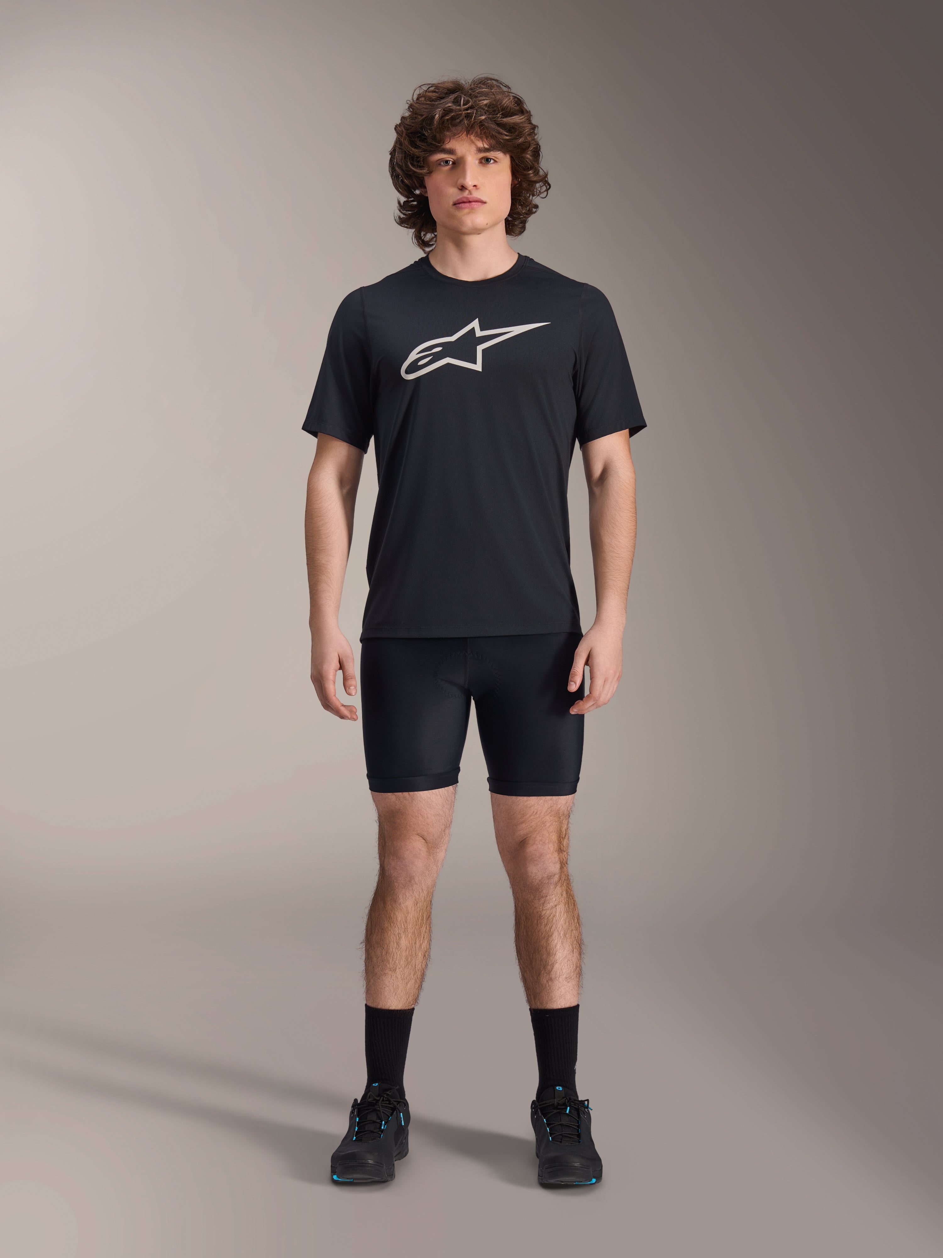 Alpinestars A-Dura Liner Shorts, Black cycling liner shorts, worn by a model with a black Alpinestars logo t-shirt and black cycling shoes, tight-fitting design for MTB performance and in-saddle comfort.